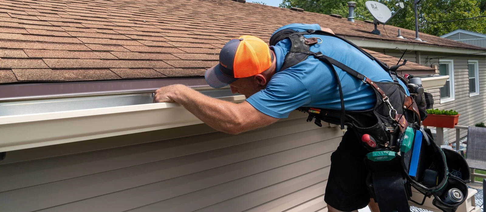 Professional seamless gutter installation on a home